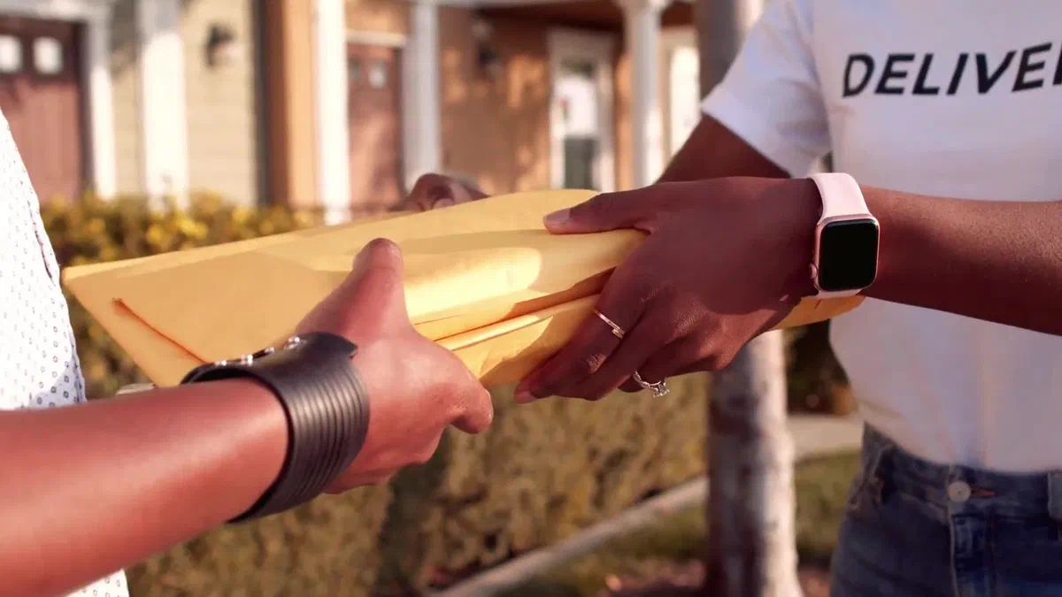 Package being handed off at a residential address